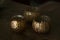 Three golden ornamental candle holders wiith copy space against dark background