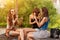 Three good girlfriends eat ice cream on a bench in the City