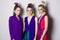 Three gorgeous fashion models with colorful make up and in bright designers clothes