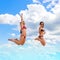 Three gorgeous women are jumping on the beach against the blue sky