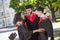 Three graduates hugging and discussing their graduation