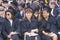 Three graduates smiling during their ceremony