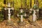 Three graves with crosses rickety and wreaths at the cemetery