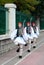 Three Greek guards marching in national costumes