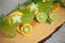 Three green cocktails standink on wood, decorated with orange, carambola, lime and rosemary. Ready to party