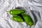 Three green hot jalapeno peppers