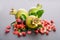 Three green pomegranates with seeds and leaves with petals