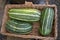 Three green vegetable marrows in a basket