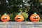 Three grinning Jack-O-Lanterns