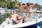 Three guys stand on a boat on the river bank