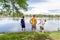 Three guys standing by the water in the park spending quality ti