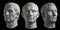 Three gypsum copy of ancient statue head of Guy Julius Caesar isolated on black background. Plaster sculpture man face.