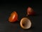 Three half parts of onion husk. Low key arts composition, dark background. Onion husk on a table.