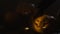 Three Halloween Pumpkins head lantern with burning candles on a black background on wooden table with knife and spoon