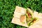 Three hamburgers lie on wooden boards on a lawn in a garden on a