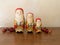 Three Handpainted Wooden Nesting Dolls Painted as Santa Claus in a Row