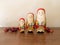 Three Handpainted Wooden Santa Claus Dolls with Red Berries