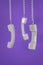 Three handsets hanging on wires on a purple background. Minimal concept