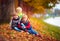 Three handsome kids, friends together in autumn park