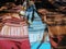 Three handwoven silk scarves on a market table in Laos