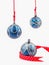 Three hanging Christmas baubles isolated on white