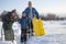 Three happy boys on sled and Skis in winter forest outdoors. Children active game