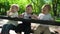 Three happy children sitting on a bench in the park