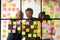 Three happy diverse colleagues team write ideas on sticky notes