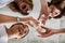 Three happy female friends drinking champagne cheers together laughing having positive emotion