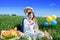 Three happy kids sitting on picnic on the field. blue sky, green grass. bread, pies and fruits in a basket.