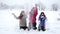 Three happy kids throwing snow on winter park, slow motion