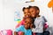 Three happy little black kids close portrait hug