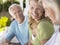 Three Happy Mature People Sitting On Verandah