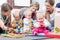 Three happy mothers watching their babies playing with safe toys