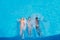 Three happy multiethnic women swimming on backs in pool