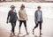 Three happy senior women walking and exercising together on beach. Retirement and healthy lifestyle