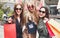 Three Happy Woman Laughing With Colorful Shopping Bags