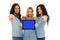 Three happy women presenting tablet\'s screen and pointing the f