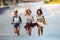 Three happy young girls with skateboards