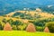 Three haystacks on beautiful summer plateau in Carpathian mountain