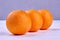 Three healthy oranges on wooden background.