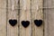 Three heart shape blackboards hanging on clothespin on string ag