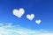 three heart shaped clouds on blue sky