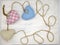 Three hearts sewn from scraps of fabric and tied with coarse thread on a light wooden background. A symbol of love and loyalty