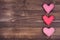 Three hearts on wood background