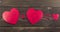 Three hearts on a wooden background heart