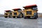 Three heavy dump trucks for the carriage of goods in the quarry.