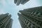 Three high-rise buildings leaving up in the long term against the background of the blue sky, the residential area of the big city