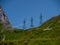 three high voltage post power poles high up in the mountains high voltage tower switzerland alps