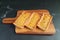 Three of Homemade Pumpkin Tartlets on Wooden Breadboard